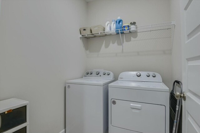 clothes washing area featuring washer and dryer and laundry area