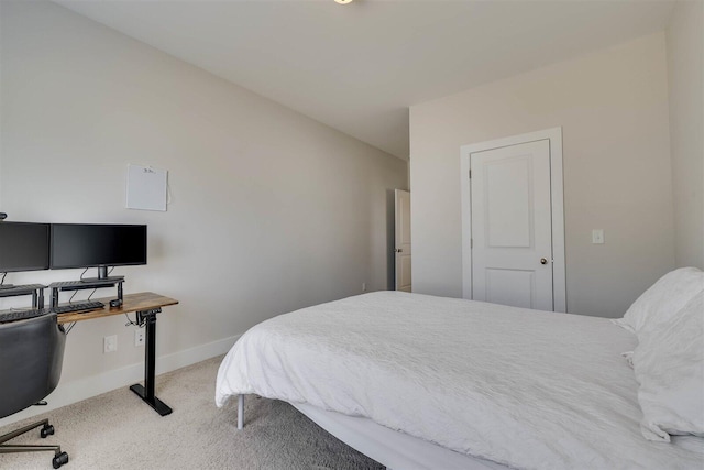 bedroom with baseboards and light colored carpet