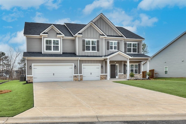 craftsman house with central air condition unit, an attached garage, board and batten siding, a front yard, and driveway