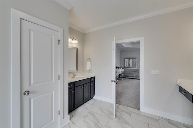 bathroom featuring ornamental molding, marble finish floor, vanity, and baseboards