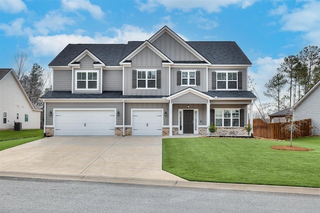 craftsman-style home with central AC unit, an attached garage, fence, board and batten siding, and a front yard