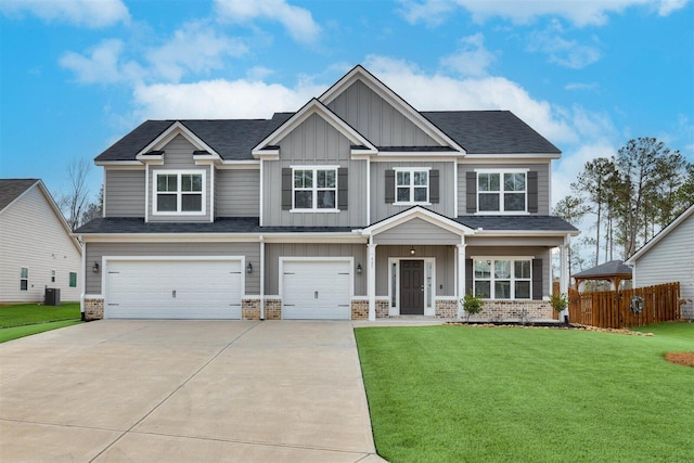 craftsman-style home with an attached garage, brick siding, board and batten siding, and a front yard