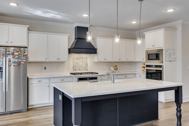 kitchen with white cabinetry, light countertops, appliances with stainless steel finishes, hanging light fixtures, and custom range hood