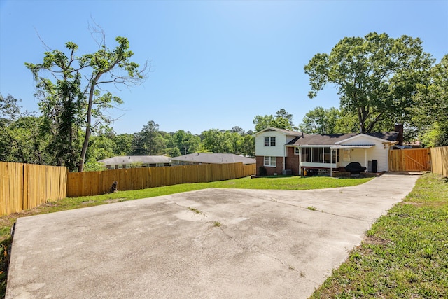2905 Rocky Creek Rd, Augusta, GA 30906 - view of front of property featuring fence private yard, a front yard, a gate, brick siding, and concrete driveway