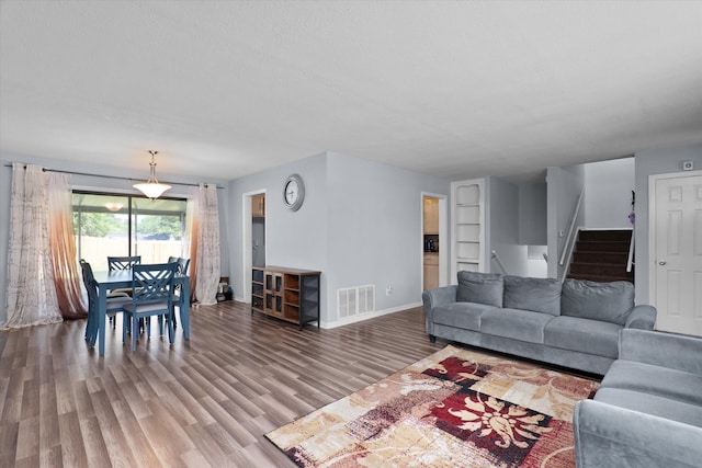 2905 Rocky Creek Rd, Augusta, GA 30906 - living area featuring wood finished floors, baseboards, visible vents, and stairs