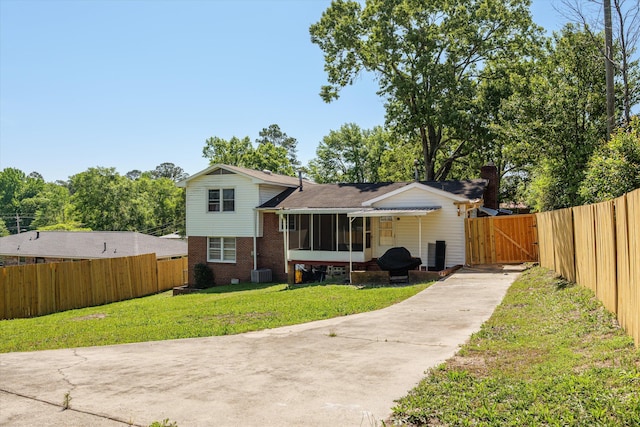 2905 Rocky Creek Rd, Augusta, GA 30906 - rear view of property featuring fence, driveway, a gate, and a lawn