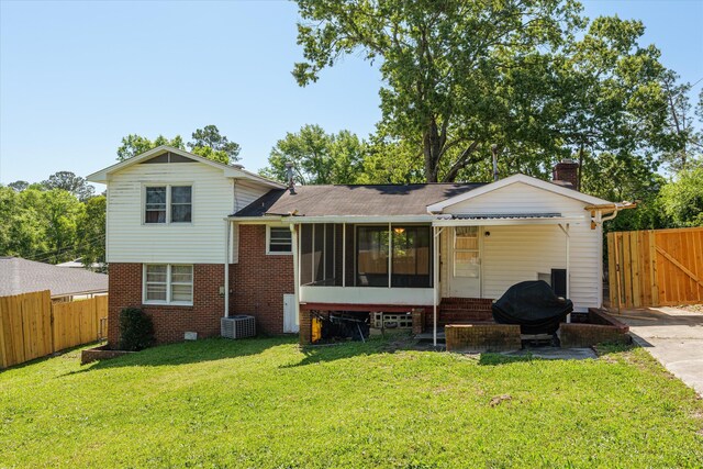 2905 Rocky Creek Rd, Augusta, GA 30906 - rear view of house featuring a sunroom, a yard, fence, and brick siding