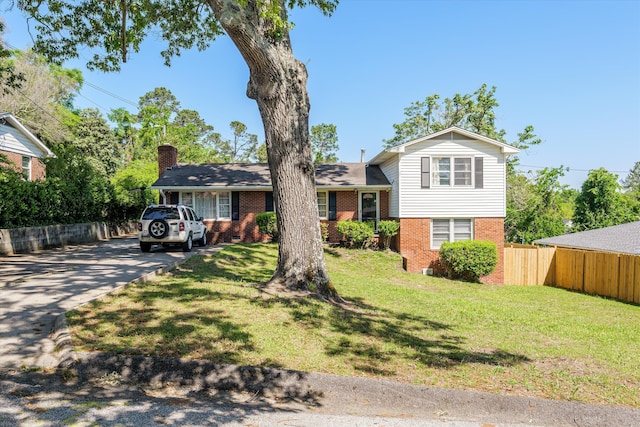 2905 Rocky Creek Rd, Augusta, GA 30906 - tri-level home with a front yard, brick siding, driveway, and fence