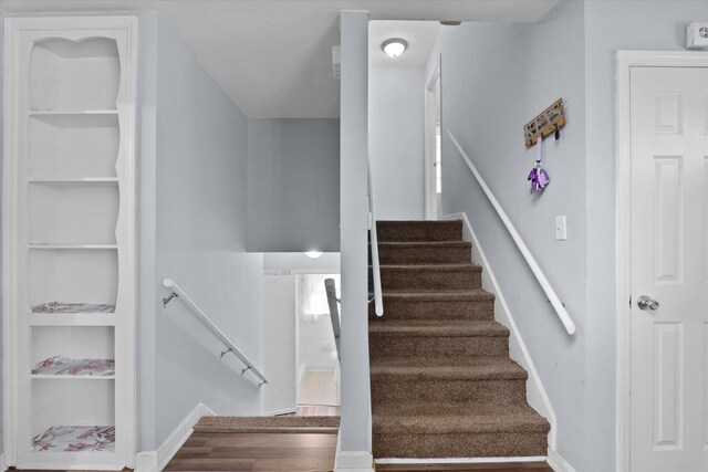 2905 Rocky Creek Rd, Augusta, GA 30906 - staircase with built in shelves, wood finished floors, and baseboards