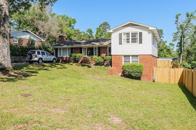 2905 Rocky Creek Rd, Augusta, GA 30906 - split level home with brick siding, a chimney, fence, and a front lawn