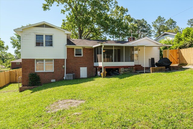 2905 Rocky Creek Rd, Augusta, GA 30906 - back of house with a sunroom, a lawn, a fenced backyard, and a gate