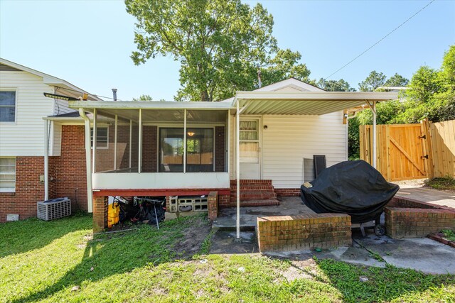 2905 Rocky Creek Rd, Augusta, GA 30906 - rear view of property with a gate, brick siding, entry steps, a yard, and a sunroom