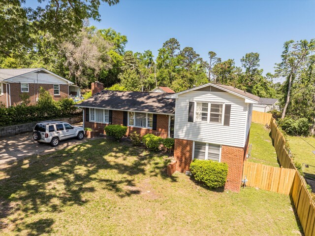 2905 Rocky Creek Rd, Augusta, GA 30906 - split level home with brick siding, a front lawn, fence, and a chimney
