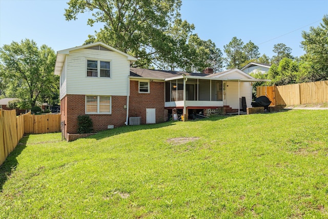 2905 Rocky Creek Rd, Augusta, GA 30906 - rear view of house featuring a sunroom, a yard, a fenced backyard, brick siding, and a gate