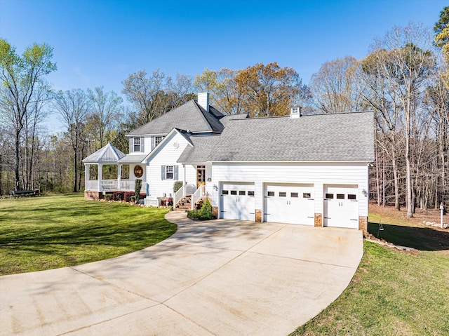 view of property with a front yard and a garage