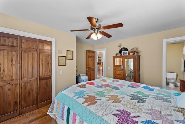 bedroom featuring a closet, ensuite bath, ceiling fan, and hardwood / wood-style flooring