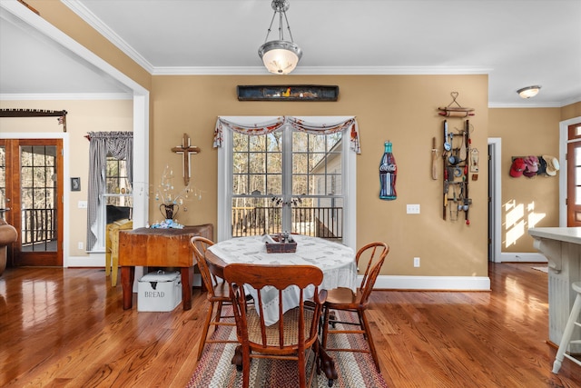 dining space with french doors, hardwood / wood-style flooring, and ornamental molding