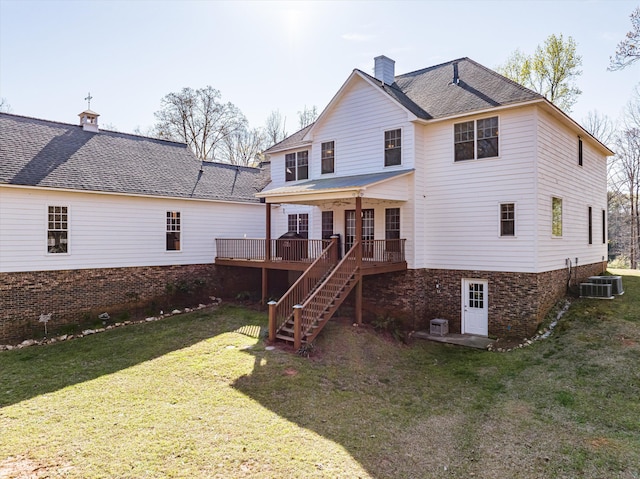 back of property featuring cooling unit, a deck, and a yard