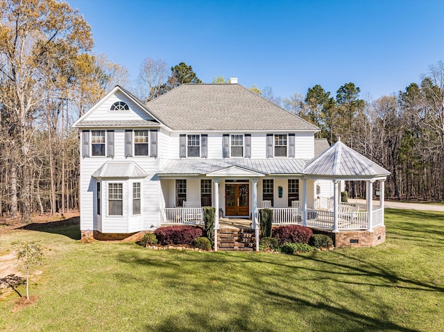 view of front of property featuring covered porch and a front yard