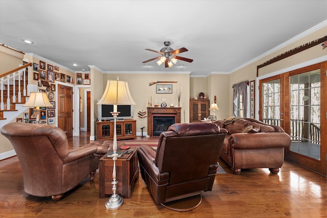 living room featuring ceiling fan, ornamental molding, dark wood-type flooring, and french doors