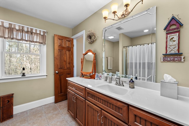 bathroom with tile patterned flooring, vanity, and walk in shower