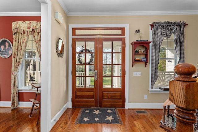 doorway to outside featuring french doors, hardwood / wood-style flooring, and crown molding