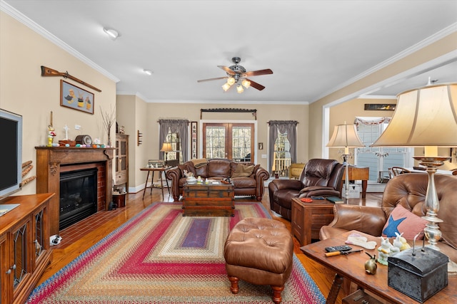 living room featuring crown molding, ceiling fan, and wood-type flooring