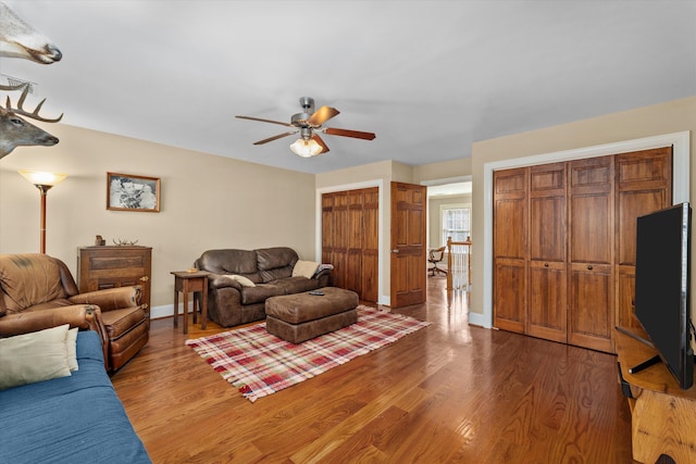 living room featuring hardwood / wood-style flooring and ceiling fan