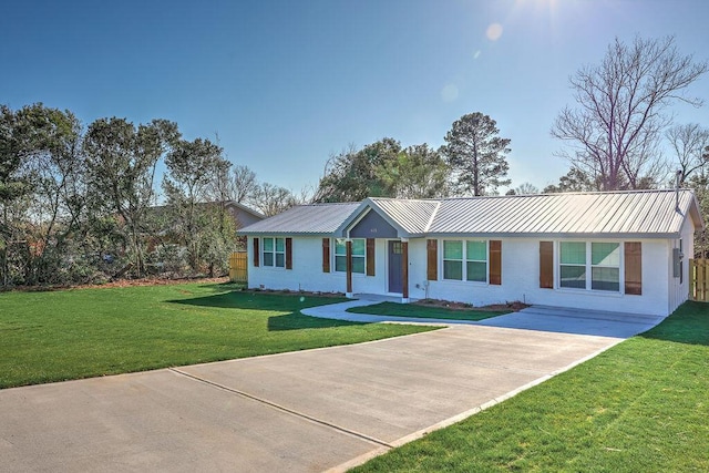 ranch-style house featuring metal roof, a front lawn, and brick siding