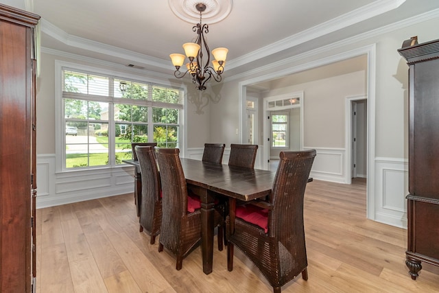 5191 Windmill Pl, Evans, GA 30809 - dining space featuring a chandelier, light wood-type flooring, ornamental molding, a wainscoted wall, and a decorative wall