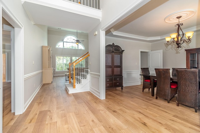 5191 Windmill Pl, Evans, GA 30809 - foyer entrance with a chandelier, ornamental molding, stairway, light wood finished floors, and a wainscoted wall