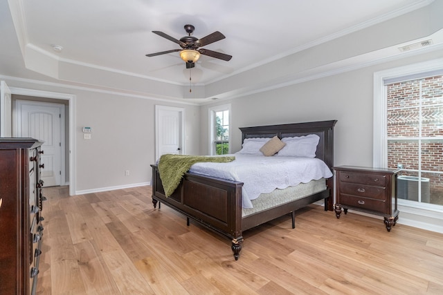 5191 Windmill Pl, Evans, GA 30809 - bedroom featuring a tray ceiling, light wood-style flooring, crown molding, a ceiling fan, and a closet