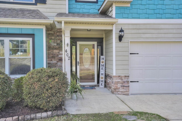 view of exterior entry with a garage