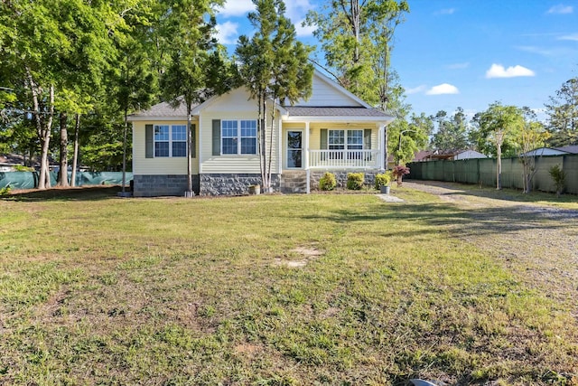 bungalow-style house with a porch, crawl space, fence, a front lawn, and roof with shingles