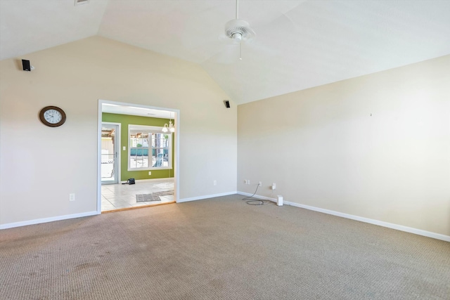 unfurnished room with ceiling fan, baseboards, carpet flooring, and lofted ceiling