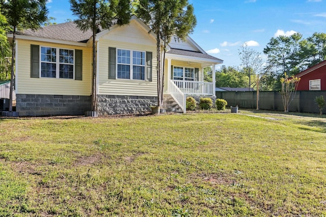 exterior space with crawl space, cooling unit, a porch, roof with shingles, and a front lawn