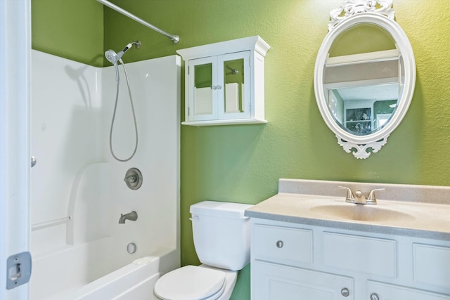 full bath featuring toilet, vanity, a textured wall, and washtub / shower combination