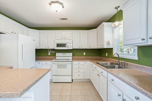 kitchen with visible vents, a sink, white appliances, and white cabinets