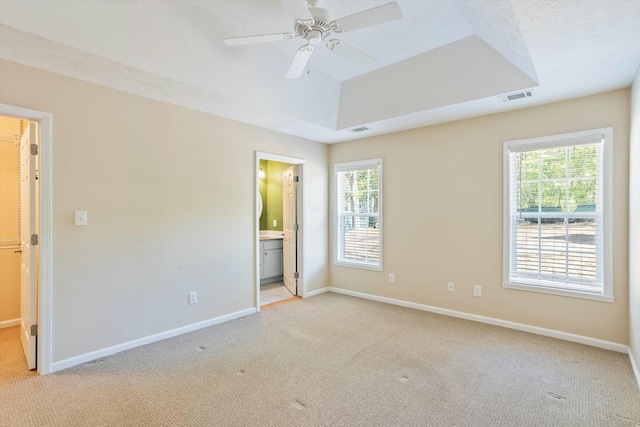 unfurnished bedroom with light carpet, multiple windows, and visible vents