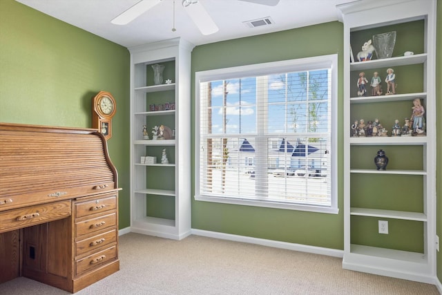 office featuring light carpet, visible vents, baseboards, and ceiling fan