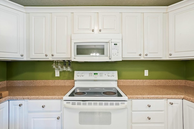 kitchen with white cabinets, white appliances, and light countertops