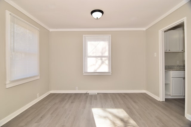 unfurnished dining area featuring light hardwood / wood-style flooring and crown molding