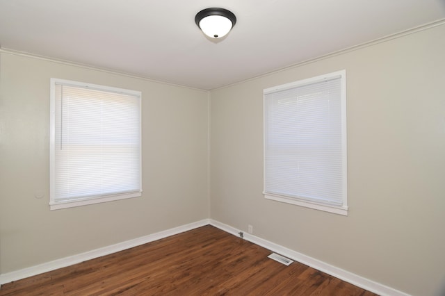 unfurnished room with dark wood-type flooring