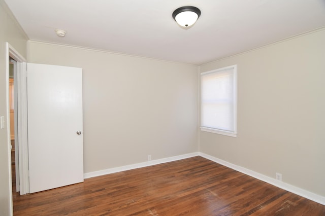 unfurnished room with dark wood-type flooring