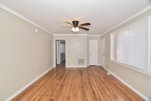 spare room with wood-type flooring, ceiling fan, and ornamental molding