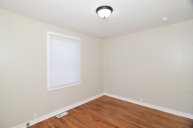 spare room with hardwood / wood-style floors