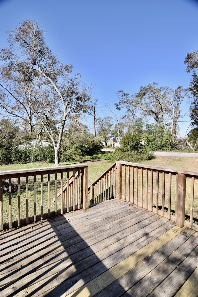 wooden terrace with a lawn