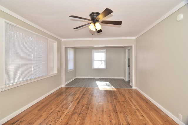 spare room featuring hardwood / wood-style floors, ceiling fan, and crown molding