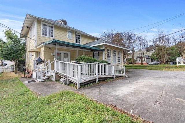 rear view of house with french doors and covered porch