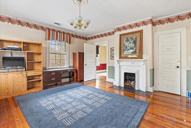 living room featuring a notable chandelier, dark hardwood / wood-style floors, a textured ceiling, and a baseboard radiator